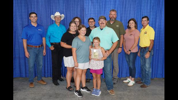 Pictured is the Franks Family: Kayla Franks, Matt Franks, McKinley Franks and McKena Franks. Back row, left to right: Blake Rollins, Chief Administrative Officer, Missouri Farm Bureau; Ed Adams, Missouri State Fair Commissioner; Sarah Traub, Interim Associate Vice Chancellor for MU Extension and Director of Education & Impact; Rob Kallenbach, MU Associate Dean of Extension and Senior Program Director of Agriculture & Environment; Jason Moore, Missouri State Fair Director; Jamie Johansen, Missouri State Fair Commissioner; and Todd Hayes, Vice President, Missouri Farm Bureau.