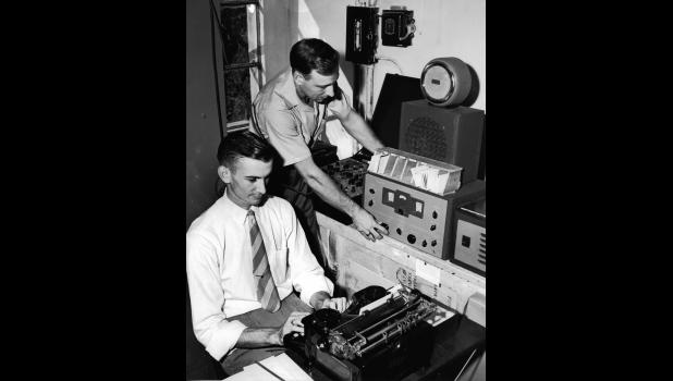 Operator Glenn Barnett (Standing) and Radio Chief Alexander receiving Morse Code Traffic 1946