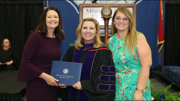 Chancellor Zora Mulligan, center, presents the honorary degree to Sgt. Lionel Daughtery's two daughters, Dr. Caron Daughtery Mitchell, left, and Casey Daughtery, right. photo provided